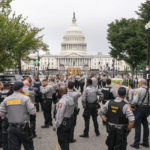 
              Police stage at a security fence ahead of a rally near the U.S. Capitol in Washington, Saturday, Sept. 18, 2021. The rally was planned by allies of former President Donald Trump and aimed at supporting the so-called "political prisoners" of the Jan. 6 insurrection at the U.S. Capitol. (AP Photo/Nathan Howard)
            