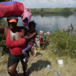 
              Haitian migrants use a dam to cross into and from the United States from Mexico, Saturday, Sept. 18, 2021, in Del Rio, Texas. The U.S. plans to speed up its efforts to expel Haitian migrants on flights to their Caribbean homeland, officials said Saturday as agents poured into a Texas border city where thousands of Haitians have gathered after suddenly crossing into the U.S. from Mexico. (AP Photo/Eric Gay)
            