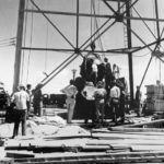 
              FILE - In this July 6, 1945, file photo, scientists and other workers rig the world's first atomic bomb to raise it up onto a 100-foot tower at the Trinity bomb test site near Alamagordo, N.M. A bipartisan group of lawmakers is renewing the push to expand a federal compensation program for radiation exposure following uranium mining and nuclear testing carried out during the Cold War. Advocates have been trying for years to bring awareness to the lingering effects of nuclear fallout surrounding the Trinity Site in southern New Mexico and on the Navajo Nation, where more than 30 million tons of ore were extracted over decades to support U.S. nuclear activities. (AP Photo/File )
            