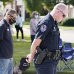 
              Officer Ben Hubbard, of the Collierville Police Department, prays during a vigil at the Collierville Town Hall, Friday, Sept. 24, 2021, in Collierville, Tenn. The vigil is for the person killed and those injured when a gunman attacked people in a Kroger grocery store Thursday before he was found dead of an apparent self-inflicted gunshot wound. (AP Photo/Mark Humphrey)
            