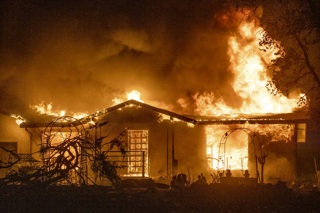 FILE - In this Sept. 27, 2020, file photo, a house burns on Platina Road at the Zogg Fire near Ono,...