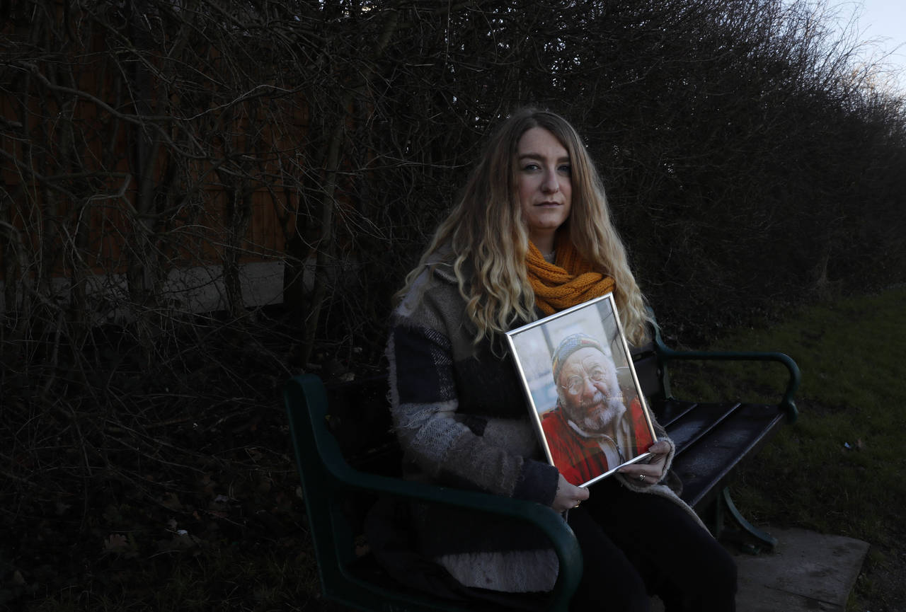 FILE - In this Friday, Jan. 22, 2021 file photo, Jo Goodman holds a portrait of her late father Stu...
