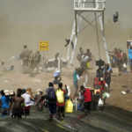 
              A dust storm moves across the area as Haitian migrants use a dam to cross into the United States from Mexico, Saturday, Sept. 18, 2021, in Del Rio, Texas. U.S. President Joe Biden's administration is nearing a final plan to expel many of the thousands of Haitian migrants who have suddenly crossed into the Texas border city from Mexico and to fly them back to their Caribbean homeland.  (AP Photo/Eric Gay)
            