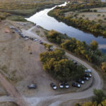 
              Official vehicles line a dirt road along the Rio Grande, Friday, Sept. 24, 2021, in Del Rio, Texas. (AP Photo/Julio Cortez)
            
