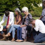 
              People pray during a vigil at the Collierville Town Hall, Friday, Sept. 24, 2021, in Collierville, Tenn. The vigil is for the person killed and those injured when a gunman attacked people in a Kroger grocery store Thursday before he was found dead of an apparent self-inflicted gunshot wound. (AP Photo/Mark Humphrey)
            
