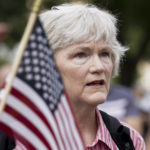 
              A person stands as the national anthem plays during a rally near the U.S. Capitol in Washington, Saturday, Sept. 18, 2021. The rally was planned by allies of former President Donald Trump and aimed at supporting the so-called "political prisoners" of the Jan. 6 insurrection at the U.S. Capitol. (AP Photo/Brynn Anderson)
            