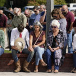 
              People pray during a vigil at the Collierville Town Hall, Friday, Sept. 24, 2021, in Collierville, Tenn. The vigil is for the person killed and those injured when a gunman attacked people in a Kroger grocery store Thursday before he was found dead of an apparent self-inflicted gunshot wound. (AP Photo/Mark Humphrey)
            