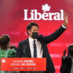 
              Liberal Leader Justin Trudeau greets supporters prior to his victory speech at Party campaign headquarters in Montreal, early Tuesday, Sept. 21, 2021.  (Paul Chiasson/The Canadian Press via AP)
            
