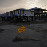 
              Sand and debris covers a road in a damaged neighborhood in the aftermath of Hurricane Ida, Monday, Sept. 6, 2021, in Grand Isle, La. (AP Photo/John Locher)
            