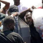 
              Haitian migrants carry provisions as they use a dam to cross into and from the United States from Mexico, Saturday, Sept. 18, 2021, in Del Rio, Texas. The U.S. plans to speed up its efforts to expel Haitian migrants on flights to their Caribbean homeland, officials said Saturday as agents poured into a Texas border city where thousands of Haitians have gathered after suddenly crossing into the U.S. from Mexico. (AP Photo/Eric Gay)
            