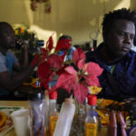 
              Robins Exile, of Haiti, eats at a Haitian restaurant, Monday, Sept. 20, 2021, in Tijuana, Mexico. Exile arrived to Tijuana the day before after changing his plans to head to the Texas border where thousands of Haitians have converged in recent days and now face deportation. He said messages on WhatsApp and Facebook from fellow Haitian migrants and their videos on YouTube warned him to steer clear of Ciudad Acuna, Mexico, across from Del Rio, Texas, and said it no longer is the easy place to cross into the U.S. that it was just a few weeks ago. (AP Photo/Gregory Bull)
            