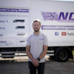 
              Laurence Bolton, the Managing Director of the National Driving Centre, poses for a portrait backdropped by a sign on the side of a truck showing different truck and vehicle categories, at the National Driving Centre in Croydon, south London, Wednesday, Sept. 22, 2021. Britain doesn't have enough truck drivers. The shortage is contributing to scarcity of everything from McDonald's milkshakes to supermarket produce. (AP Photo/Matt Dunham)
            