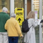 
              A voter provides COVID-19 contact-tracking information at the Halifax Convention Centre as they prepare to vote in the federal election in Halifax on Monday, Sept. 20, 2021.  (Andrew Vaughan/The Canadian Press via AP)
            