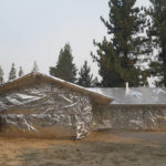 
              FILE - In this Sept. 1, 2021 file photo Martin Diky's home completely wrapped in fire-resistant material to protect the property against the approaching Caldor Fire in Meyers, Calif. Diky decided to order $6,000 worth of aluminum protective covering to wrap his home near Lake Tahoe in June as the last big wildfire roared through the Sierra dozens of miles southwest of the forested alpine waters. (AP Photo/Jae C. Hong,File)
            