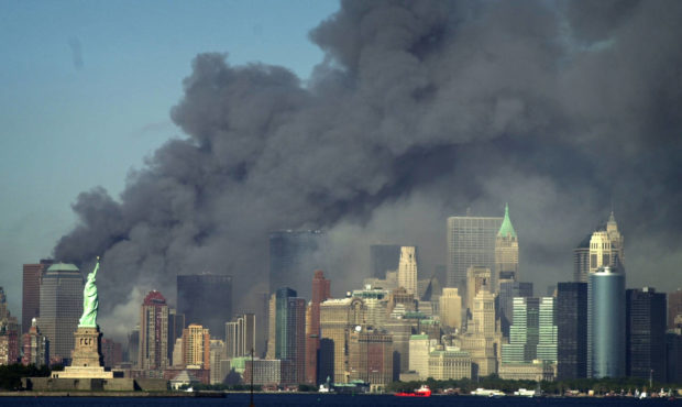 Thick smoke billows into the sky from the area behind the Statue of Liberty, lower left, where the ...