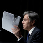 
              Secretary of State Antony Blinken holds up documents while speaking at a Senate Committee on Foreign Relations hearing on the U.S. withdrawal from Afghanistan, on Capitol Hill in Washington, Tuesday, Sept. 14, 2021. (AP Photo/Andrew Harnik)
            