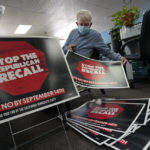 
              FILE - In this July 29, 2021, file photo, volunteer Merle Canfield assembles yard signs against the Sept. 14, recall election of Gov. Gavin Newsom, at the Fresno County Democratic Party headquarters in Fresno, Calif. Democratic state lawmakers Sen. Steve Glazer and Assemblyman Marc Berman called for reforming the recall election requirements, Wednesday Sept. 15, 2021. This could include increasing the number of signatures to force a recall election, raising the standards to require malfeasance on the part of the office-holder and change the current process in which someone with a small percentage of votes could replace a sitting governor. (AP Photo/Rich Pedroncelli, File)
            