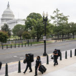 
              Police stage at a security fence ahead of a rally near the U.S. Capitol in Washington, Saturday, Sept. 18, 2021. The rally was planned by allies of former President Donald Trump and aimed at supporting the so-called "political prisoners" of the Jan. 6 insurrection at the U.S. Capitol. (AP Photo/Nathan Howard)
            