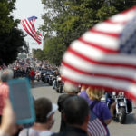 
              Thousands of people on motorcycles drive past the crowd during the funeral procession for Marine Corps Cpl. Humberto Sanchez on East Market Street on Sunday, Sept. 12, 2021, in Logansport, Ind. Sanchez was among 13 U.S. service members killed in a suicide bombing during the U.S.-run evacuation at Afghanistan’s Kabul airport on Aug. 26. (Christine Tannous /The Indianapolis Star via AP)
            