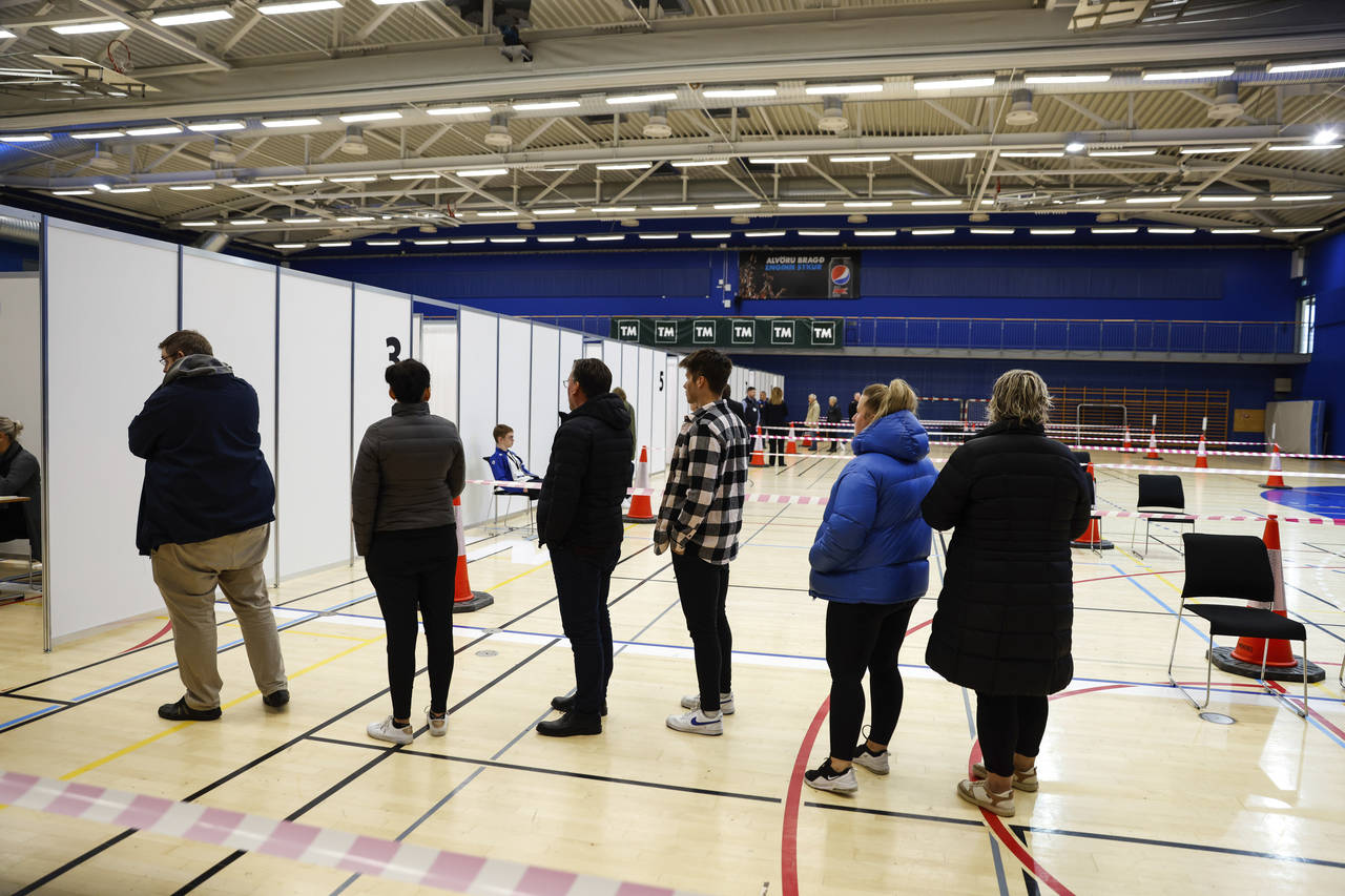 People line-up to vote at a polling station in Gardabae, Iceland, Saturday, Sept. 25, 2021. Iceland...