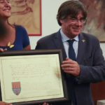 
              Catalan separatist leader Carles Puigdemont, right, flanked by Speaker of the Catalan Parliament Laura Borras exchanges gifts with Mayor of Alghero Mario Conoci in Alghero, Sardinia, Italy, Saturday, Sept. 25, 2021. Puigdemont was visiting the city hall after he took a leisurely walk in the Sardinian city, waving to supporters, a day after a judge freed him from jail pending a hearing on his extradition to Spain, where the political firebrand is wanted for sedition. (AP Photo/Andrea Rosa)
            