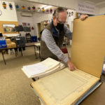 Bob Kelly examines a recently acquired “Track Record” from the old Northern Pacific Railway. (Feliks Banel/KIRO Radio)