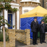 
              Police officers stand outside a house in north London, thought to be in relation to the death of Conservative MP Sir David Amess, Sunday, Oct. 17, 2021. Leaders from across Britain's political spectrum have come together to pay tribute to a long-serving British lawmaker who was stabbed to death in what police have described as a terrorist attack. (AP Photo/Alberto Pezzali)
            