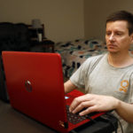
              Graham Berryman looks at his laptop at his apartment in Springfield, Mo., on Thursday, Oct. 21, 2021. Berryman is a lawyer that his struggled to find work during the pandemic after he was let go by his previous firm in August 2020. He is concerned that his unemployment benefits will soon end. (AP Photo/Bruce E. Stidham)
            