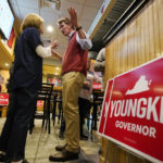 
              Virginia Republican gubernatorial candidate Glenn Youngkin greets a supporter during a meet and greet at a sports bar in Chesapeake, Va., Monday, Oct. 11, 2021. Youngkin faces former Governor Terry McAuliffe in the November election. (AP Photo/Steve Helber)
            