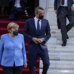 
              German Chancellor Angela Merkel, walks with Greece's Prime Minister Kyriakos Mitsotakis, as she leaves Maximos Mansion, at the end of the meeting in Athens, Greece, Friday, Oct. 29, 2021. Germany's outgoing Chancellor Angela Merkel is on a two-day visit to the country whose financial crisis marked much of her tenure and Germany's relationship with Europe. (AP Photo/Thanassis Stavrakis)
            