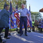 
              Voting rights activist Stacey Abrams, left, arrives on stage during a rally with Democratic gubernatorial candidate, former Virginia Gov. Terry McAuliffe in Norfolk, Va., Sunday, Oct. 17, 2021. Abrams was in town to encourage voters to vote for the Democratic gubernatorial candidate in the November election. (AP Photo/Steve Helber)
            