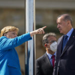 
              German Chancellor Angela Merkel, left, talks to Turkish President Recep Tayyip Erdogan on the occasion of their meeting at Huber Villa presidential palace, in Istanbul, Turkey, Saturday, Oct. 16, 2021. (AP Photo/Francisco Seco)
            