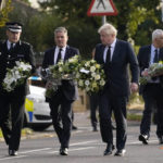 
              British Prime Minister Boris Johnson and Leader of the Labour Party Keir Starmer, second from left, carry flowers as they arrive at the scene where a member of Parliament was stabbed Friday, in Leigh-on-Sea, Essex, England, Saturday, Oct. 16, 2021. David Amess, a long-serving member of Parliament was stabbed to death during a meeting with constituents at a church in Leigh-on-Sea on Friday, in what police said was a terrorist incident. A 25-year-old man was arrested in connection with the attack, which united Britain's fractious politicians in shock and sorrow. (AP Photo/Alberto Pezzali)
            