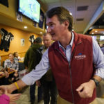 
              Virginia Republican gubernatorial candidate Glenn Youngkin greets supporters during a meet and greet at a sports bar in Chesapeake, Va., Monday, Oct. 11, 2021. Youngkin faces former Governor Terry McAuliffe in the November election. (AP Photo/Steve Helber)
            