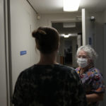 
              A 25-year-old woman from Texarkana, Texas, whose husband and nursing toddler waited outside in their car, is guided by lab technician Stephannie Chaffee as she goes to meet with a doctor to be given pills and guidance for a medical abortion, Saturday, Oct. 9, 2021, at Hope Medical Group for Women in Shreveport, La. The nation's most restrictive abortion law is driving many women from Texas to seek services in neighboring states. The woman said she was already five weeks along before she realized she was pregnant, and she knew it would be impossible to schedule the required two visits at a Texas clinic. (AP Photo/Rebecca Blackwell)
            