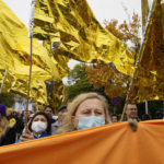 
              People join a protest in solidarity with migrants who have been pushed back at Poland's border with Belarus, in Warsaw, Poland, on Sunday, Oct. 17, 2021. Thousands of people have marched in Warsaw in solidarity with migrants and asylum-seekers at the Poland-Belarus border who have been pushed back by Polish authorities. (AP Photo/Czarek Sokolowski)
            