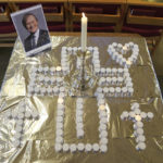 
              Candles and a photo at a vigil at St Michael & All Angels church in Leigh-on-Sea in Essex, England, Sunday Oct. 17, 2021 for Conservative MP Sir David Amess who died after he was stabbed several times at a constituency surgery on Friday. (Kirsty O'Connor/PA via AP)
            