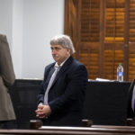 
              William "Roddie" Bryan, center, walks out of the jury selection room in handcuffs during jury selection for the trial at the Glynn County Courthouse, Monday, Oct. 25, 2021, in Brunswick, Ga. Bryan, Greg and Travis McMichael are charged with the slaying of 25-year-old Ahmaud Arbery in February 2020. (AP Photo/Stephen B. Morton, Pool)
            
