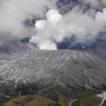 
              Smoke rises from a crater of Mr. Aso, Kumamoto prefecture, southwestern Japan, Wednesday, Oct. 20, 2021. The volcano erupted Wednesday with a massive column of gray smoke billowing into the sky. (Kyodo News via AP)
            