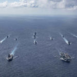 
              In this photo released by the U.S. Indo-Pacific Command, the United Kingdom's carrier strike group led by HMS Queen Elizabeth (R 08), and Japan Maritime Self-Defense Forces led by (JMSDF) Hyuga-class helicopter destroyer JS Ise (DDH 182) joined with U.S. Navy carrier strike groups led by flagships USS Ronald Reagan (CVN 76) and USS Carl Vinson (CVN 70) sails to conduct multiple carrier strike group operations in the Philippine Sea, on Oct. 3, 2021. After sending a record number of military aircraft to harass Taiwan over China’s National Day holiday weekend, Beijing has toned down the sabre rattling but tensions remain high, with the rhetoric and reasoning behind the exercises unchanged. (Jason Tarleton/U.S. Navy via AP)
            