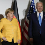 
              German Chancellor Angela Merkel, left, and U.S. President Joe Biden pose for the media at the La Nuvola conference center for the G20 summit in Rome, Saturday, Oct. 30, 2021. The two-day Group of 20 summit is the first in-person gathering of leaders of the world's biggest economies since the COVID-19 pandemic started. (AP Photo/Kirsty Wigglesworth, Pool)
            