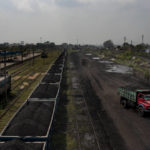 
              A truck loaded with coal drives past a stationary freight train carrying coal at Chainpur village near Hazaribagh, in eastern state of Jharkhand, Sunday, Sept. 26, 2021. A 2021 Indian government study found that Jharkhand state -- among the poorest in India and the state with the nation’s largest coal reserves -- is also the most vulnerable Indian state to climate change. Efforts to fight climate change are being held back in part because coal, the biggest single source of climate-changing gases, provides cheap electricity and supports millions of jobs. It's one of the dilemmas facing world leaders gathered in Glasgow, Scotland this week in an attempt to stave off the worst effects of climate change. (AP Photo/Altaf Qadri)
            