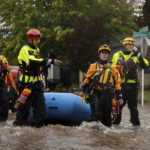 
              Santa Rosa firefighters check for residents trapped by floodwaters on Neotomas Avenue in Santa Rosa, Calif., on Sunday, Oct. 24, 2021. (AP Photo/Ethan Swope)
            