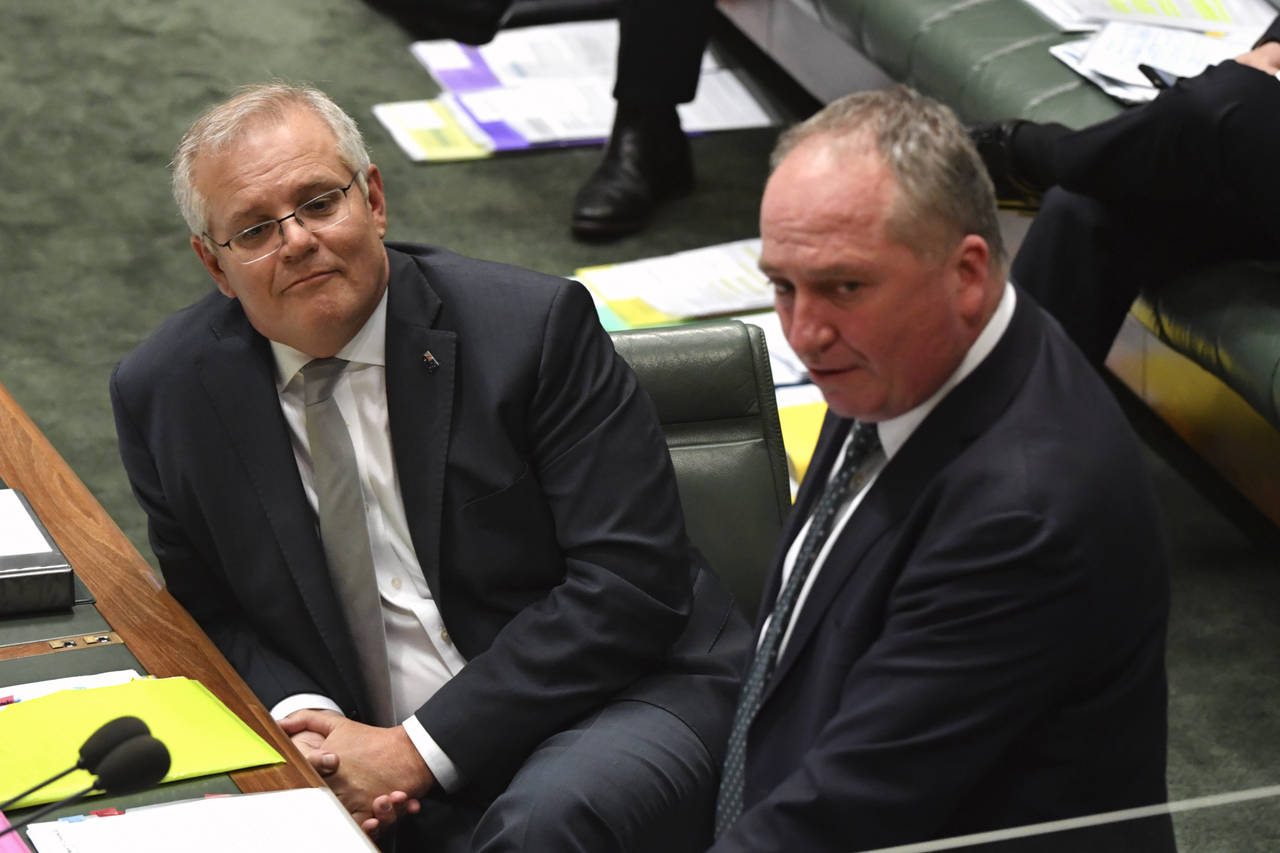 Australia's Prime Minister Scott Morrison, left, listens to Deputy Prime Minister Barnaby Joyce dur...