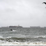 
              A wind surfer surfs in the rain in Long Beach, Calif., on Monday, Oct. 25, 2021. (Brittany Murray/The Orange County Register via AP)
            