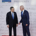 
              U.S. President Joe Biden, right, speaks with Italy's Prime Minister Mario Draghi as he arrives at the La Nuvola conference center for the G20 summit in Rome, Saturday, Oct. 30, 2021. The two-day Group of 20 summit is the first in-person gathering of leaders of the world's biggest economies since the COVID-19 pandemic started. (AP Photo/Domenico Stinellis)
            