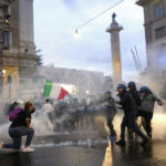 
              FILE - In this Saturday, Oct. 9, 2021 file photo, demonstrators and police clash during a protest, in Rome. An extreme-right political party's violent exploitation of anger over government anti-pandemic restrictions is forcing Italy to wrestle with its fascist legacy and fueling fears that there could be a replay of last week's mobs trying to force their way toward Parliament. (Mauro Scrobogna/LaPresse via AP)
            