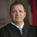 
              This photo provided by North Carolina Administrative Office of the Courts shows Associate Justice Phil Berger Jr.  One of several legal challenges to North Carolina’s contentious voter ID law is on hold amid a dispute over whether two justices on the state Supreme Court — one the son of arguably the state's most powerful Republican politician — should recuse themselves. (North Carolina Administrative Office of the Courts via AP)
            