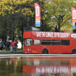 
              Protestors march alongside a bus during a climate demonstration in Brussels, Sunday, Oct. 10, 2021. Some 80 organizations are joining in a climate march through Brussels to demand change and push politicians to effective action in Glasgow later this month.(AP Photo/Geert Vanden Wijngaert)
            
