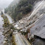 
              Rocks and vegetation cover Highway 70 following a landslide in the Dixie Fire zone on Sunday, Oct. 24, 2021, in Plumas County, Calif. Heavy rains blanketing Northern California created slide and flood hazards in land scorched during last summer's wildfires. (AP Photo/Noah Berger)
            
